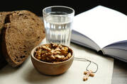 simple food and water in front of a book showing lenten fasting