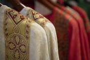 Priests’ vestments on hangers in a 2018 photo. (CNS photo/Tyler Orsburn)