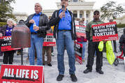 Former death row inmates who were exonerated, from left, Randall Padgent, Gary Drinkard and Ron Wright, were among the nearly 100 protestors gathered at the state capitol building in Montgomery, Ala., on Jan. 23, 2024, to ask Governor Kay Ivey to stop the planned execution of Kenneth Eugene Smith. (Mickey Welsh/The Montgomery Advertiser via AP)