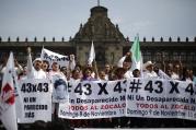 People carry banners and flags in Mexico City Nov. 9, as they take part in a protest to demand more information about the 43 missing students. They marched 112 miles from Iguala. (CNS photo/Tomas Bravo, Reuters)
