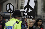 Anti war demonstrators hold banners as they protest outside Westminster Abbey, as a service to recognize 50 years of continuous deterrent at sea takes place in London on May 3. (AP Photo/Kirsty Wigglesworth)