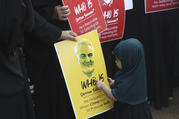 A Shiite Muslim girl points at a portrait of Iranian Gen. Qassem Soleimani, who was killed in a U.S. attack, during a protest against the United States in Mumbai, India, on Jan. 9. (AP Photo/Rafiq Maqbool)