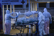 A patient in a biocontainment unit is carried on a stretcher at the Columbus Covid 2 Hospital in Rome, Monday, March 16, 2020. (AP Photo/Alessandra Tarantino)