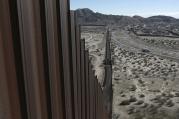 This Jan. 25, 2017, file photo shows a truck driving near the Mexico-US border fence, on the Mexican side, separating the towns of Anapra, Mexico and Sunland Park, New Mexico.  (AP Photo/Christian Torres, File)