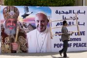 A billboard with a picture of Egyptian Coptic Pope Tawadros II, left, welcomes Pope Francis, at St. Mark's Cathedral in Cairo, Egypt, on Thursday, April 27, 2017.  (AP Photo/Amr Nabil)