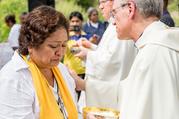 Father John I. Jenkins, president of the University of Notre Dame in Indiana, comforts a woman while distributing Communion during Mass on Oct. 15 with the Colectivo Solecito near Veracruz, Mexico. (CNS photo/Matt Cashore, University of Notre Dame)