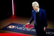 Right-wing populist leader Geert Wilders walks onto the stage in the closing debate at parliament in The Hague, Netherlands on Tuesday, March 14, 2017. (Remko de Waal ANP POOL via AP)