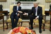 Canadian Prime Minister Justin Trudeau reaches for the hand of President Donald Trump in the Oval Office of the White House on Feb. 13, 2017. (AP Photo/Evan Vucci)