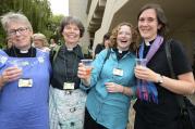 Women react after Church of England synod approves ordination of women bishops, July 14.