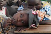 A girl displaced as a result of Boko Haram attack in the northeast region of Nigeria rests her head on a desk at a camp for internally displaced people in Yola Jan. 13. (CNS photo/Afolabi Sotunde, Reuters) 