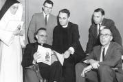 The Rev. Andrew M. Greeley, seated left, talks with fellow speakers following a symposium on "New Horizons in Catholic Thought" in 1962.