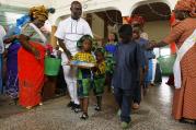 A family walks with gifts toward the altar during a New Year's Mass of thanksgiving at Holy Rosary Church in Abuja, Nigeria.