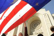 A man holds a large U.S. flag before an Oct. 14 Mass and Pilgrimage for Life and Liberty at the Basilica of the National Shrine of the Immaculate Conception in Washington. (CNS photo/Leslie E. Kossoff) (Oct. 15, 2012)