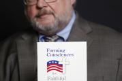 John Carr, former executive director of the U.S. bishops' Department of Justice, Peace and Human Development, is pictured Feb. 28, 2012 holding "Forming Consciences for Faithful Citizenship." 