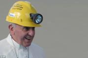 pope francis wearing a yellow safety helmet, he is smiling and wearing his white papal clothing
