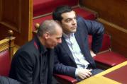 Prime Minister Alexis Tsipras, right, talks with Finance Minister Yanis Varoufakis at the Greek Parliament, Feb. 18.
