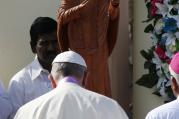 Pope Francis in front of stature of Joseph Vaz, a newly ordained saint, Jan 14 (CNS photo/Paul Haring).