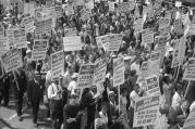 Demonstrators holding signs march during the 1963 March on Washington.