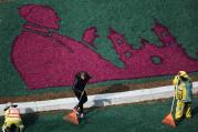 Workers put the finishing touches on an image of Pope Francis made out of flowers, on the lawn surrounding the Angel of Independence Monument in Mexico City, Wednesday, Feb. 10, 2016. Pope Francis travels to Mexico Feb. 12-18. (AP Photo/Enric Marti)