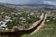 The international border fence snakes along hills in this July 16 view from east of Nogales, Ariz. Nogales in Sonora, Mexico, is more densely populated than that of its U.S. sister city. 