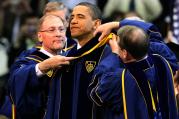 The chairman of the University of Notre Dame's board of trustees, Richard C. Notebart, and university registrar Harold L. Pace present U.S. President Barack Obama with an academic stole signifying the honorary degree he received during the commencement c eremony at the university in Notre Dame, Ind., in late May. (CNS photo/Christopher Smith)