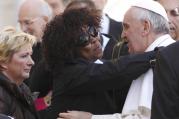 Patience Dodo of Gabon, who is blind, hugs Pope Francis as he leaves his general audience in St. Peter's Square at the Vatican, April 10, 2013.