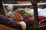 MYSTICAL ENCOUNTER. Worshippers venerate the relics of St. Maria Goretti at St. John Cantius Church in Chicago.
