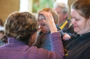 TOUCH OF GRACE. Ann Froelich, pastoral associate at St. Matthew Parish in Allouez, Wis., gives ashes.