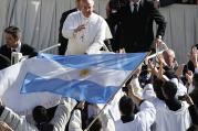 Pope Francis approaches priests with an Argentine flag as he arrives in St. Peter's Square for his inaugural Mass at the Vatican on March 19, 2013. (Photo courtesy of Reuters/Stefano Rellandini)