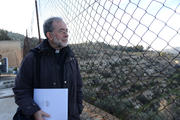 Canadian bishop looks through fence at convent in Beit Jalla, West Bank.