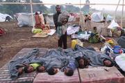 Congolese children displaced by fighting rest in open at camp in Uganda, July 13.