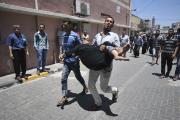 A Palestinian man rushes wounded woman into hospital in southern Gaza Strip.
