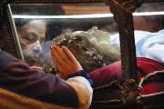 MYSTICAL ENCOUNTER. Worshippers venerate the relics of St. Maria Goretti at St. John Cantius Church in Chicago.