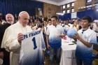 Pope Francis receives a Catholic Charities jersey and an autographed soccer ball during his meeting with immigrant families at Our Lady Queen of Angels School in the East Harlem area of New York in September 2015. (CNS photo)