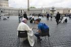 Pope Francis hears confession of a youth April 23 in St. Peter's Square at the Vatican. (CNS photo/L'Osservatore Romano via Reuters)