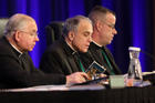 Cardinal Daniel N. DiNardo of Galveston-Houston, center, leads the opening prayer Nov. 12 during the fall general assembly of the U.S. Conference of Catholic Bishops in Baltimore. Also pictured are Archbishop Jose H. Gomez of Los Angeles, vice president of the USCCB, and Msgr. J. Brian Bransfield, general secretary. (CNS photo/Bob Roller)