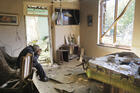 Yury Melkonyan, 64, sits in his house, damaged by shelling from Azerbaijan's artillery during a military conflict in Shosh village outside Stepanakert, the separatist region of Nagorno-Karabakh, Saturday, Oct. 17, 2020. (AP Photo)