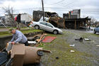 A man in Nashville, Tenn., picks up debris near his business March 3, 2020, after a tornado hit the area. In the Nashville Diocese, people and parishes, as well as Catholic Charities of Tennessee, are balancing their response to the coronavirus with ongoing tornado recovery. (CNS photo/Harrison McClary, Reuters