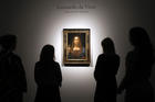 People gather around Leonardo da Vinci's 'Salvator Mundi' on display at Christie's auction rooms, in London, Tuesday, Oct. 24 (AP Photo/Kirsty Wigglesworth).