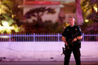 A police officer stands in front of the Tropicana hotel-casino in Las Vegas Oct. 2 after a mass shooting at a music festival. A gunman perched on the 32nd floor of a hotel unleashed a shower of bullets late Oct. 1 on an outdoor country music festival below, killing more than 50 people and wounding hundreds, making it the worst mass shooting in modern U.S. history (CNS photo/Steve Marcus, Las Vegas Suns). 