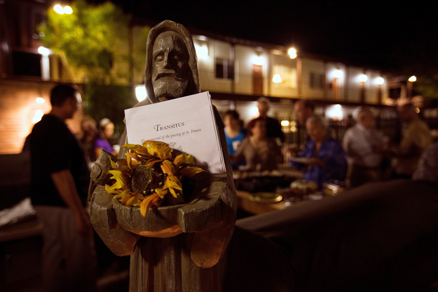 People gather outside for refreshments following the "transitus," the memorial of the passing of St. Francis of Assisi, at the Franciscan Renewal Center in Scottsdale, Ariz., Oct. 3. Each year the Franciscan community gathers on the eve of the saint's feast day recalling his last day on earth and his transition to everlasting life. St. Francis was said to have had a sweet tooth, especially for almond cookies. (CNS photo/Nancy Wiechec)