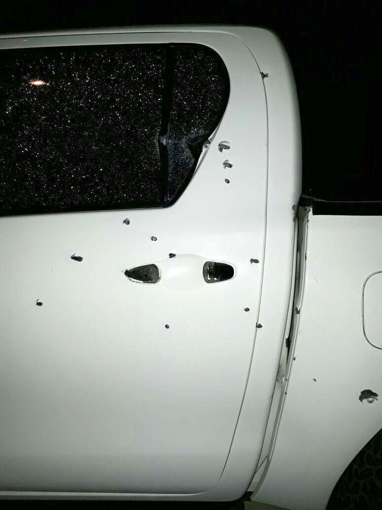 White Truck with several bullet holes