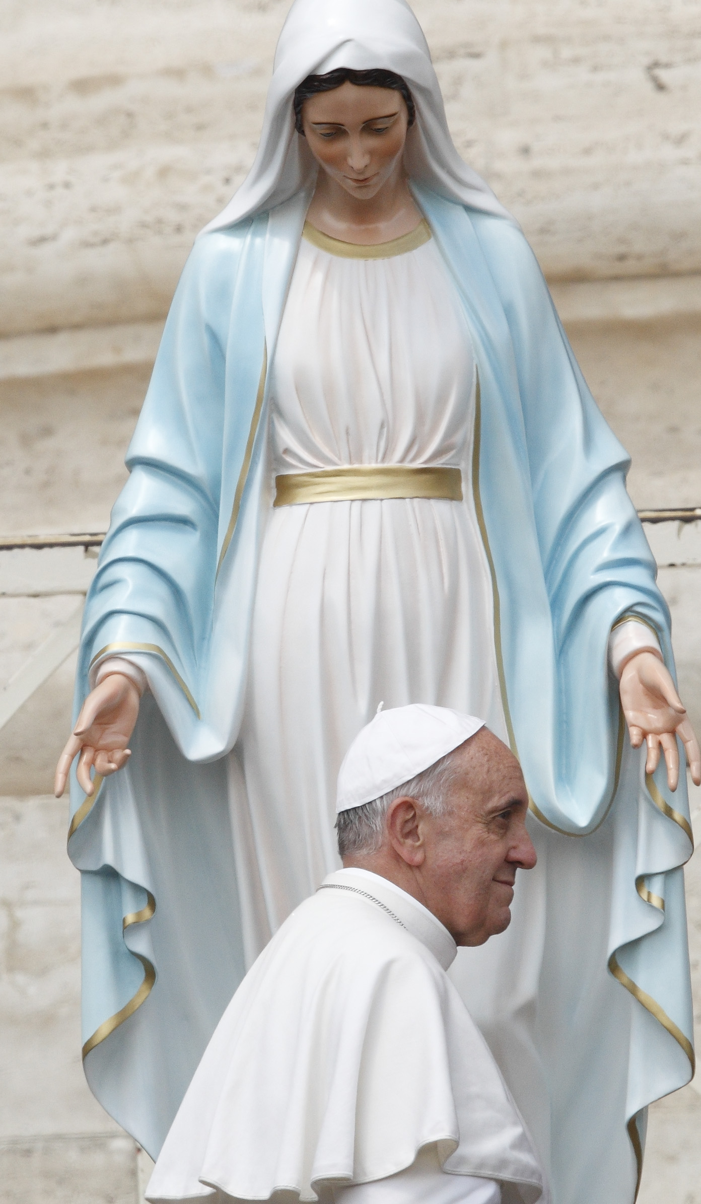 Pope Francis walks past a statue of Mary after praying in front of it during his general audience in St. Peter's Square at the Vatican, May 29, 2013. (CNS photo/Paul Haring)