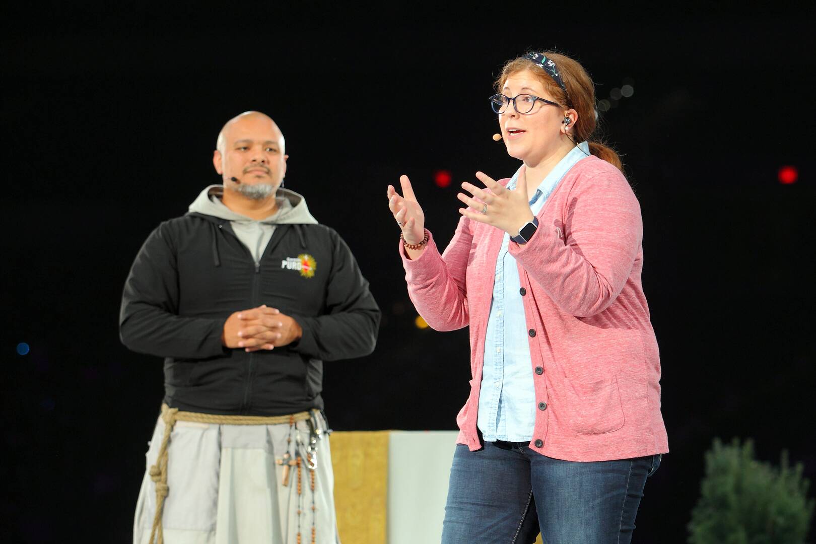 Agustino Torres, O.F.M., and Katie Prejean McGrady welcome attendees to the opening general session on Nov. 21, 2019, of the National Catholic Youth Conference in Indianapolis (CNS photo/Bob Nichols, Catholic Moment)