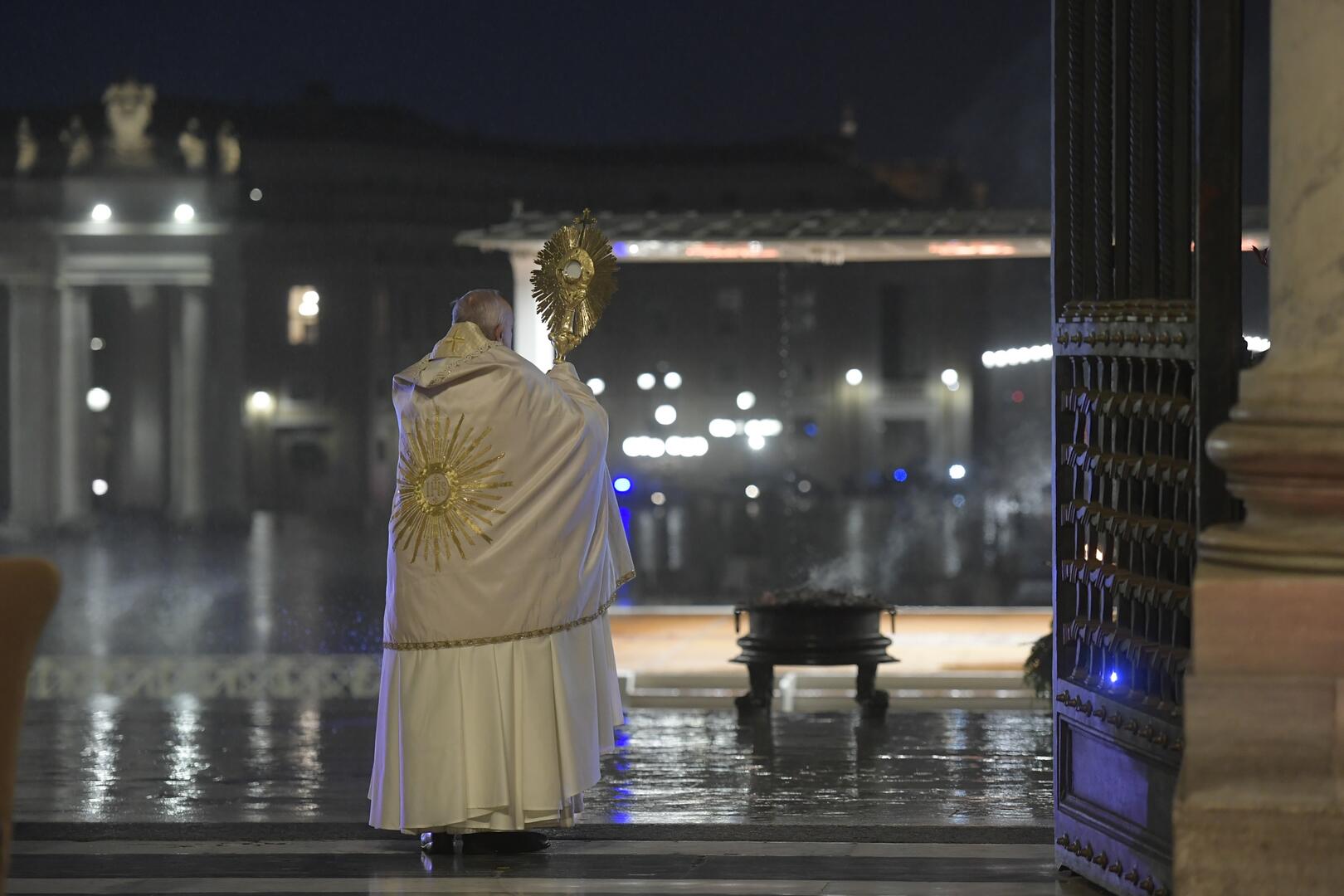 Pope Francis lifts a monstrance to an empty St. Peter's Square