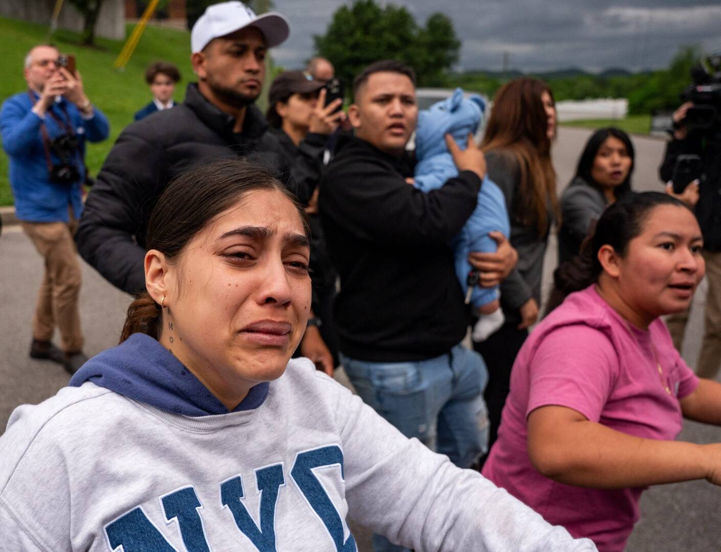 A woman cries as a bus transporting detained people leaves the Department of Homeland Security field office in Nashville where multiple immigrant rights groups gathered to protest what they believe to be a multi-agency operation to detain-noncitizens overnight in Nashville, Tenn., May 4, 2025. (OSV News photo/Seth Herald, Reuters)