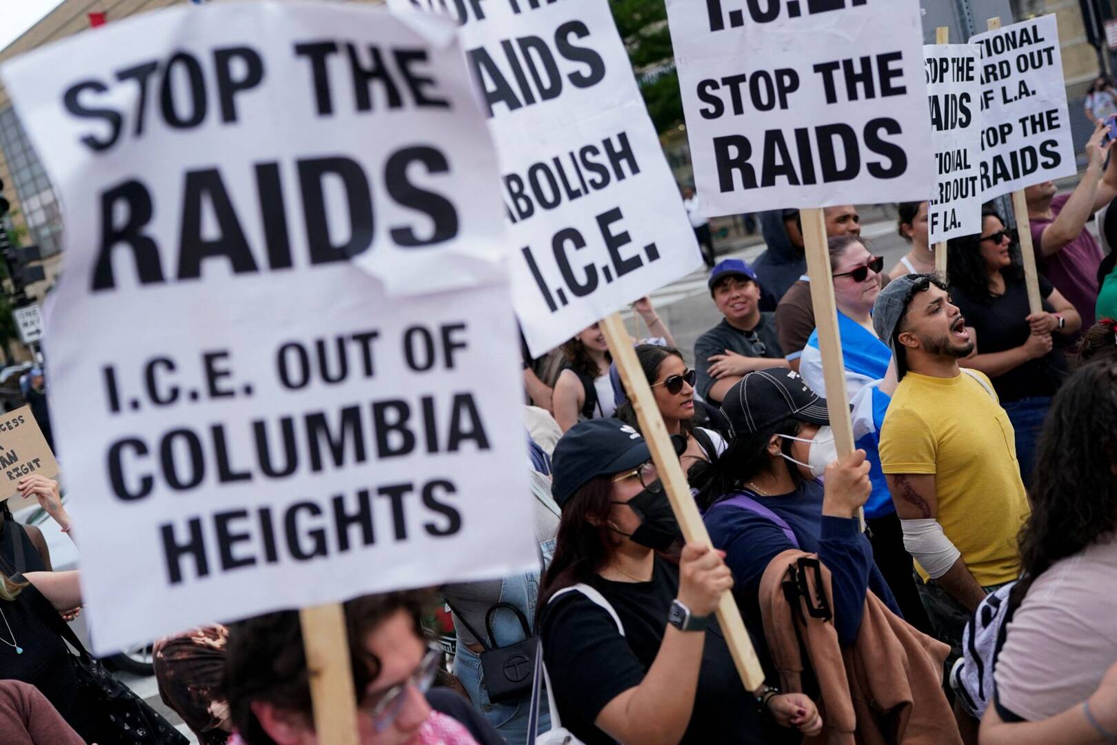People hold signs during a demonstration in Washington June 10, 2025, as part of nationwide protests in solidarity with Los Angeles protests against federal immigration sweeps. (OSV News photo/Nathan Howard, Reuters)