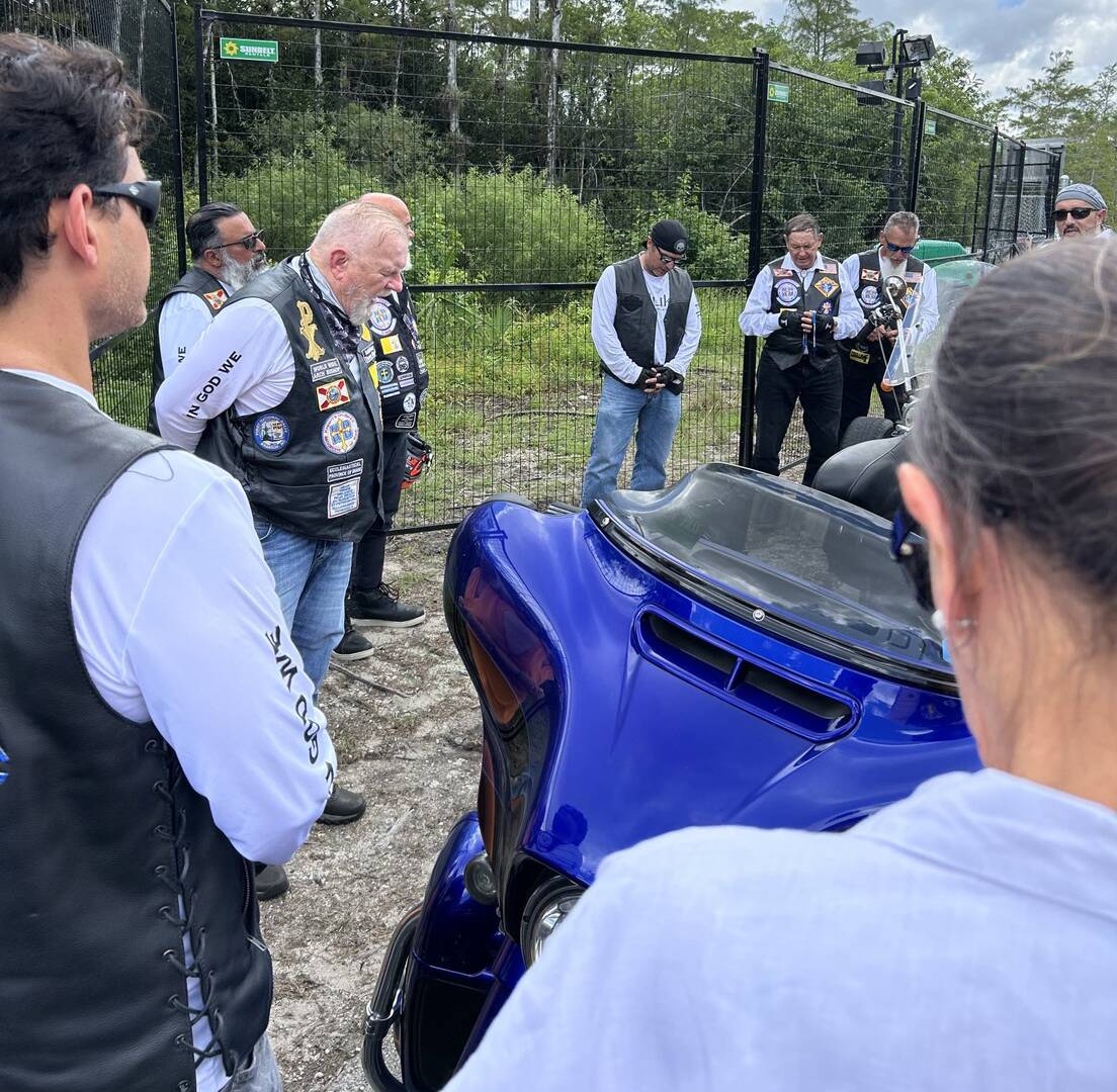 Archbishop Thomas G. Wenski of Miami and Knights on Bikes pray the rosary for detainees at the entrance to Alligator Alcatraz, a controversial immigration detention facility in some 55 miles from Miami in the Florida Everglades, July 20, 2025. (OSV News photo/Archbishop Thomas G. Wenski)