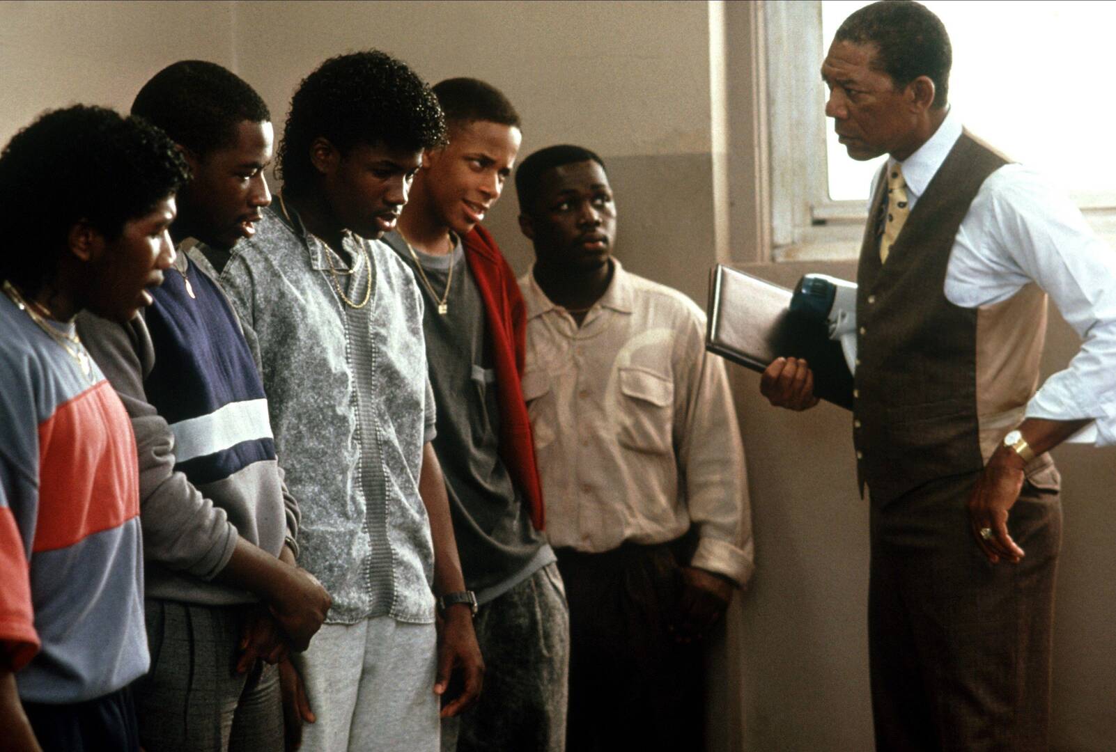 Morgan Freeman playing Joe Clarke, a principail, talking to teenaage students in the hallway