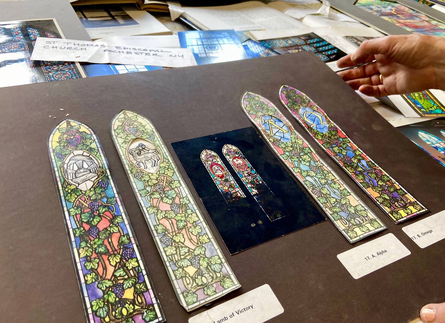scale drawings of stained glass windows on a black background